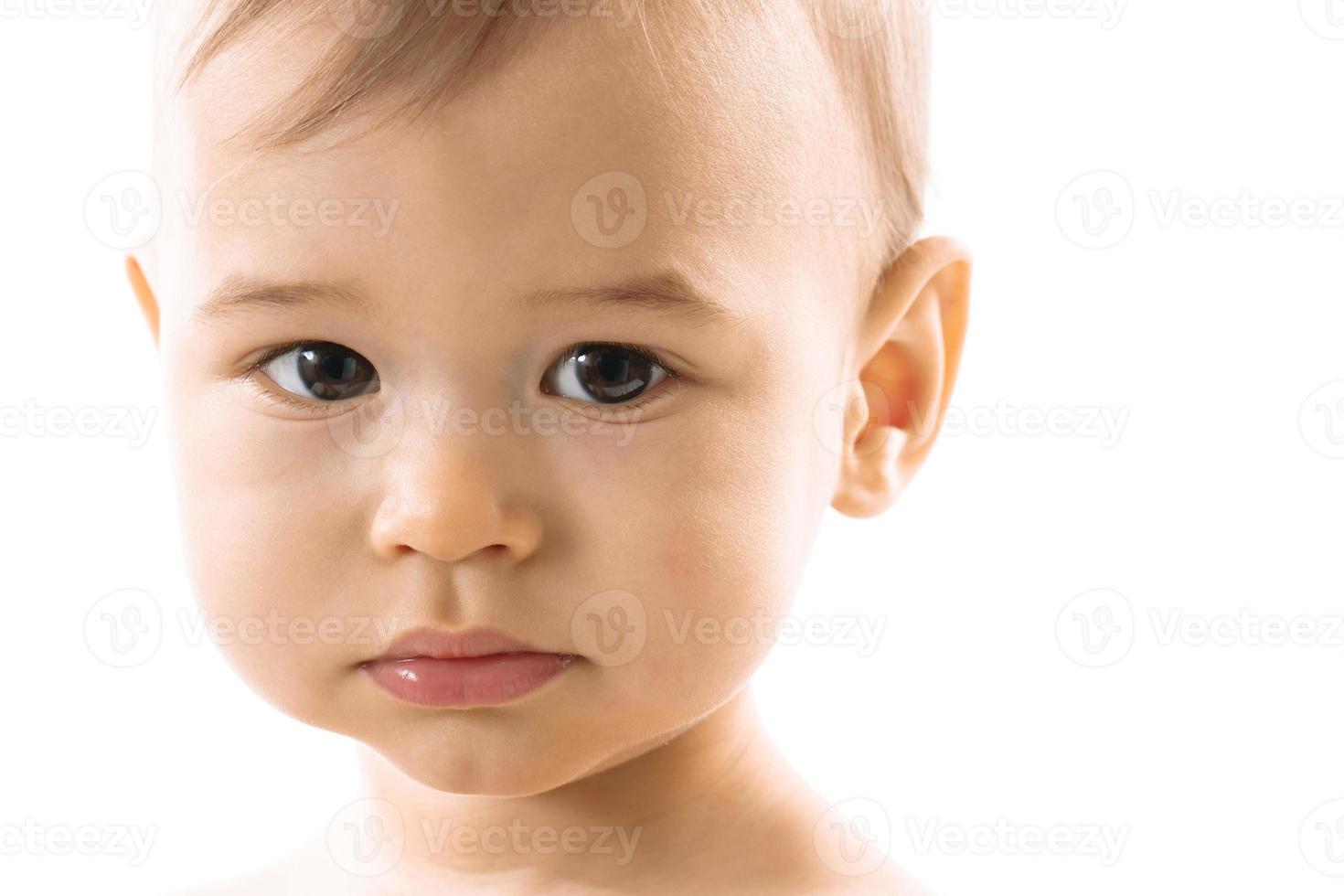 Closeup shot of serious little boy face. photo