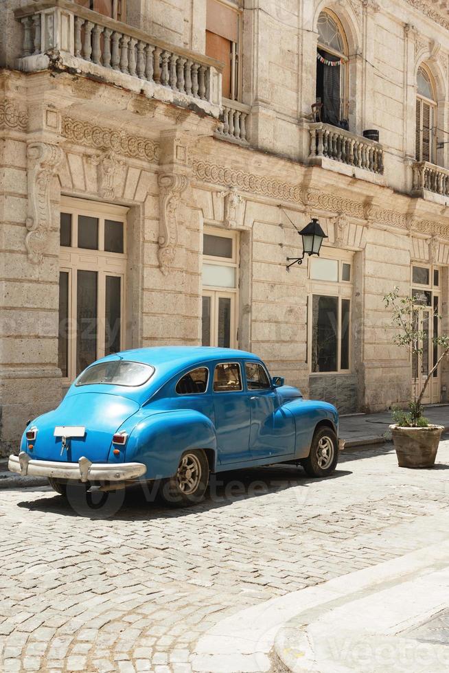 Shiny vintage blue car parked on street photo