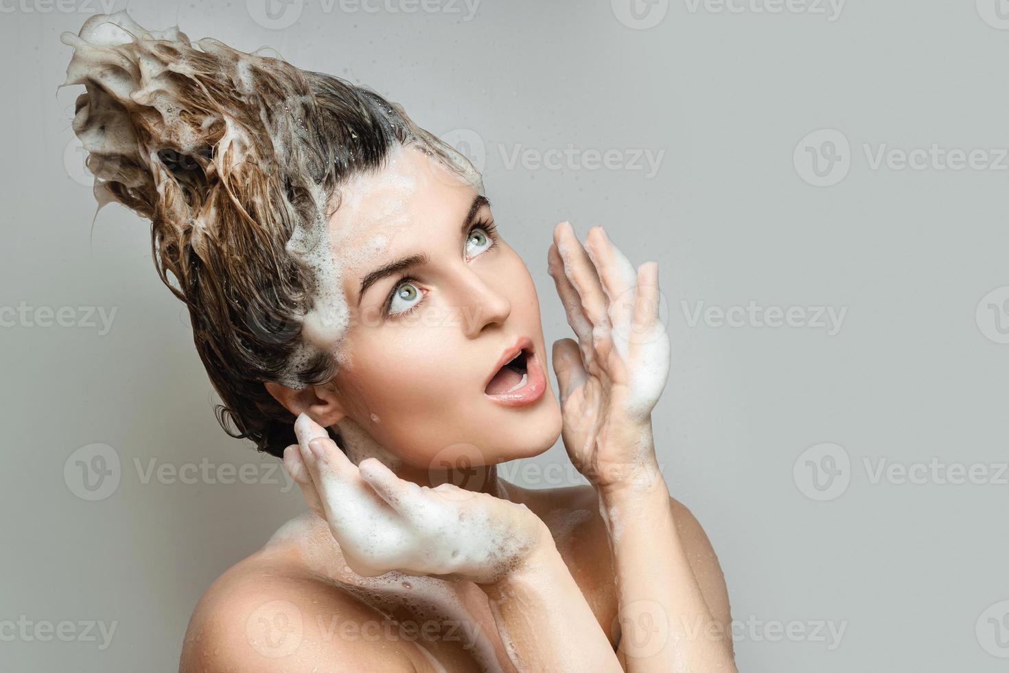 Young and funny washing her hair with a shampoo 14356129 Stock Photo at