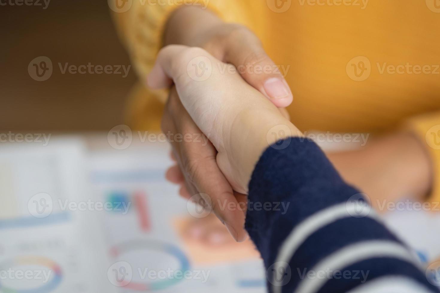 Company representatives join hands to work together on real estate projects and make profits for the company. photo