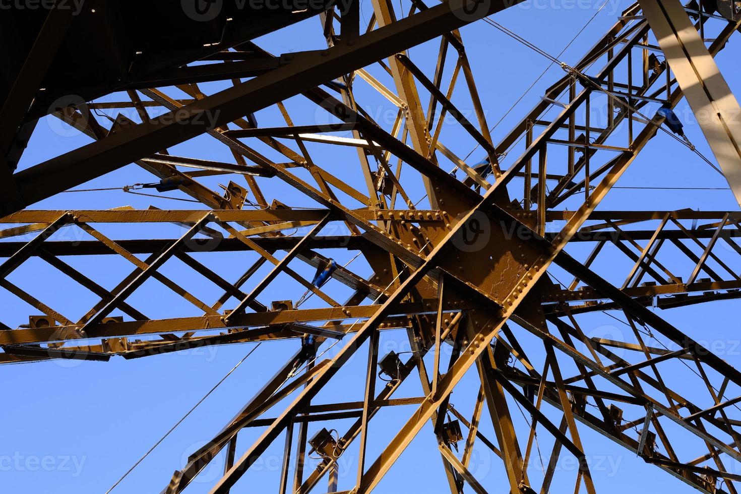 Close up Metal Structure of Eiffel Tower with Blue Sky. photo