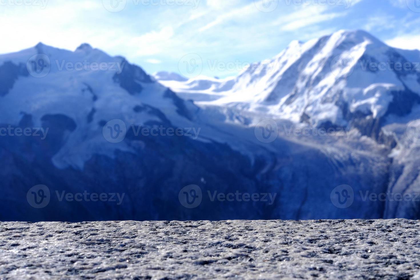 Stone Table in Selective Focus at Surface with Blurred Snow Mountain at Gornergrat Cable Station Background, Suitable for Product Presentation Backdrop, Display, and Mock up. photo