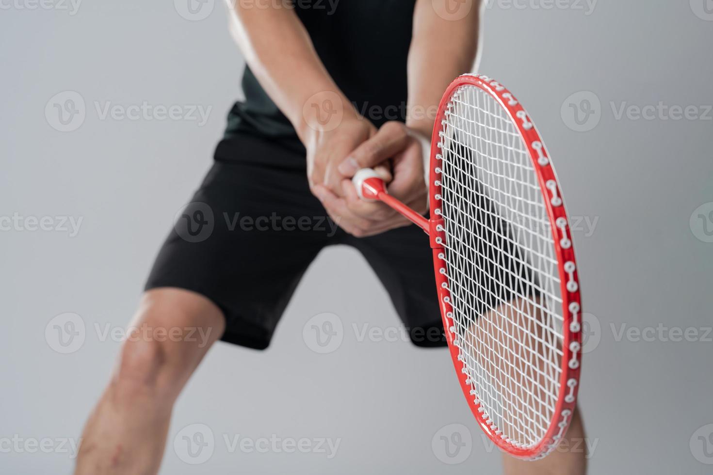 Badminton player wearing sportswear standing holding a racket photo