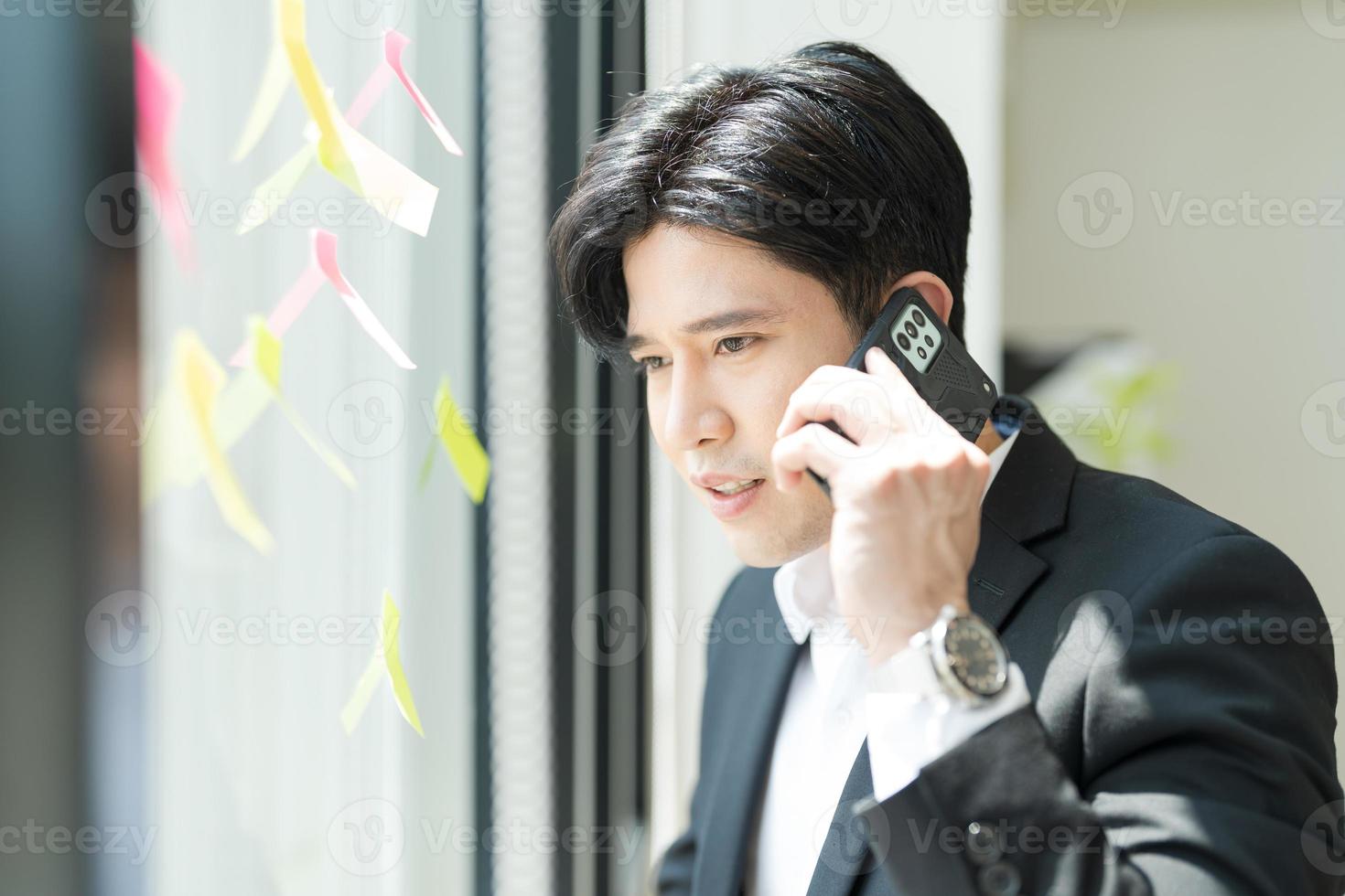 Smiling young businessman talking on the phone. photo
