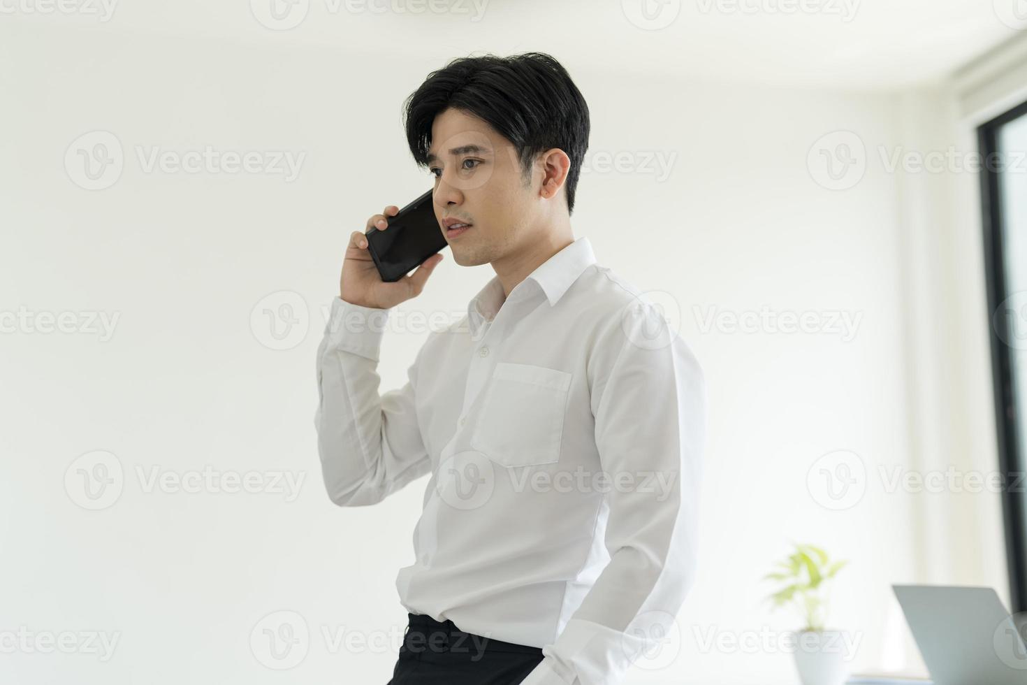 Smiling young businessman talking on the phone. photo