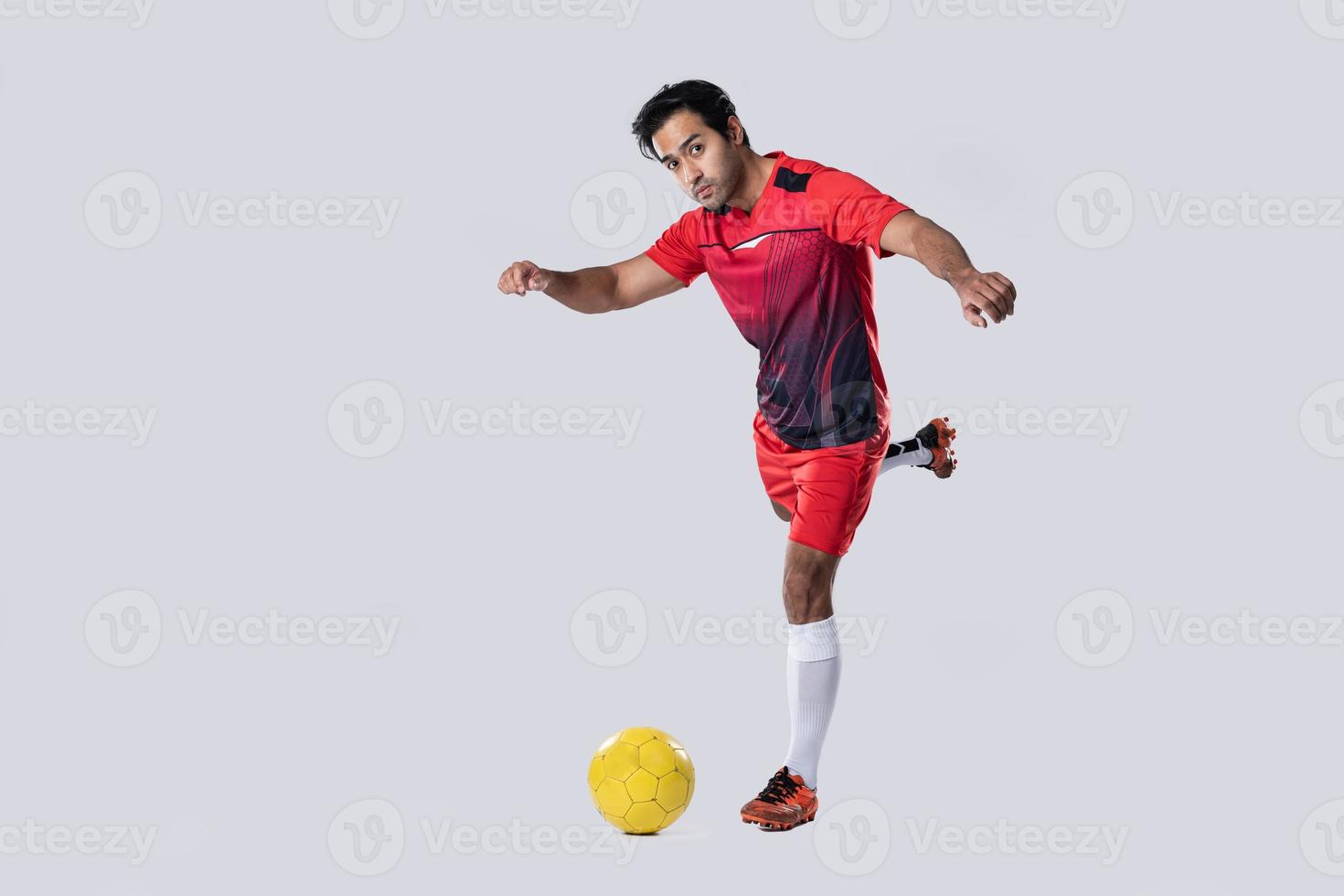 professional football player in red training uniform pose on a white background football concept Active. photo