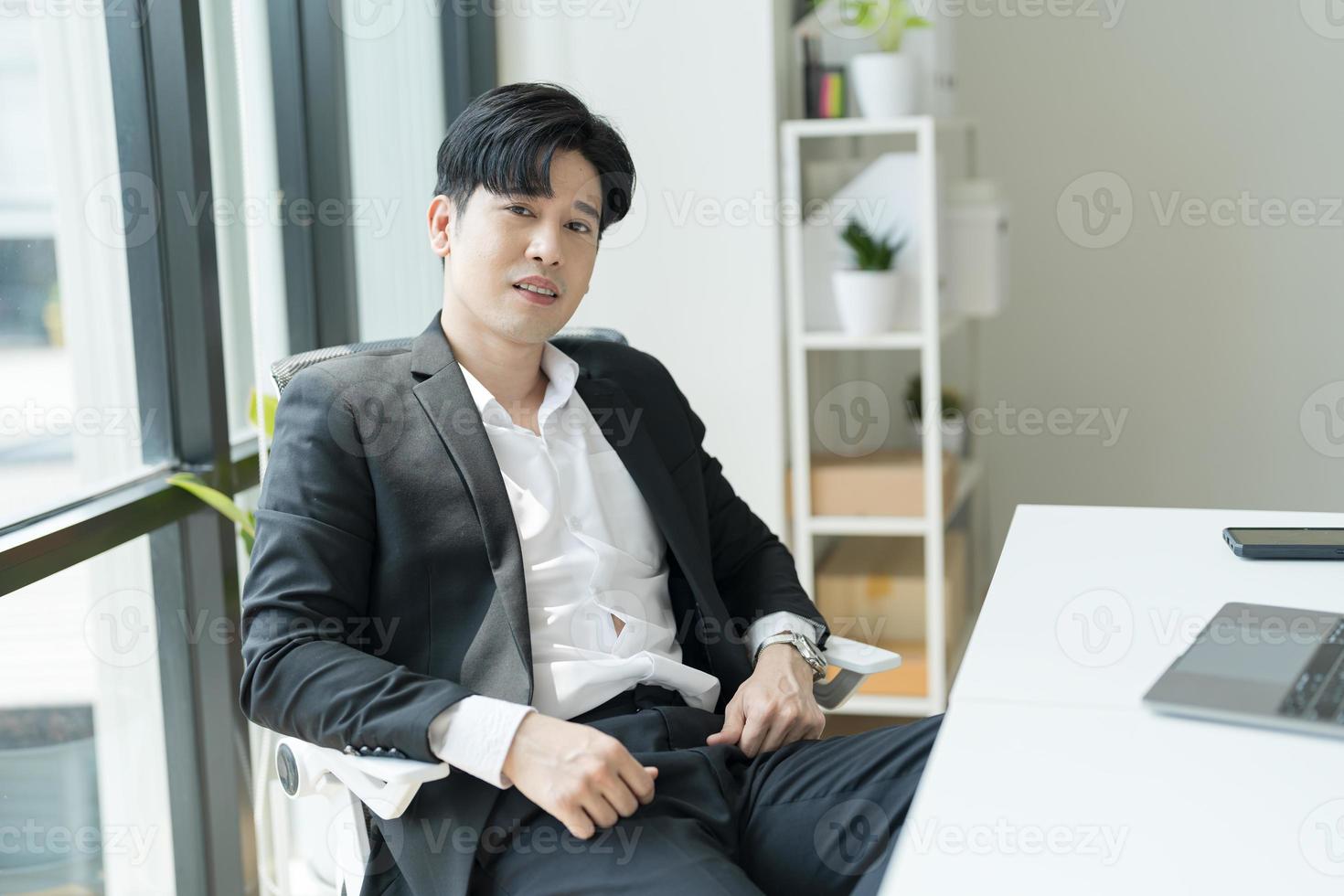 Young businessman sitting with his arms stretched out to relax After working. photo