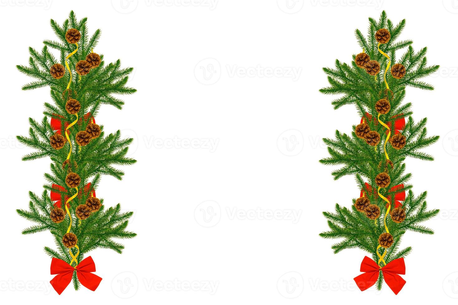 Pine tree branches with cones and red ribbon bow decoration isolated on white. photo