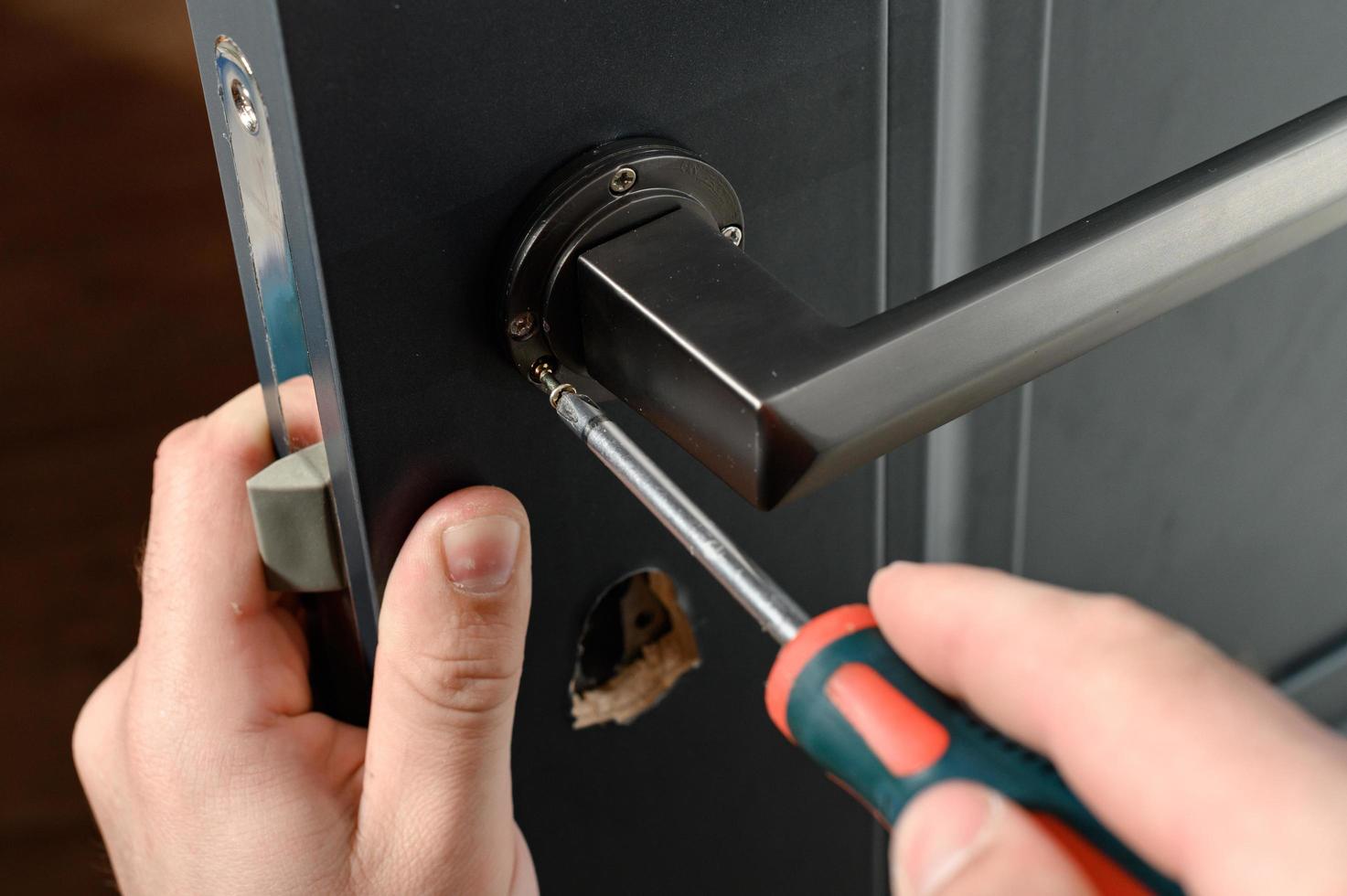Installation of a door handle on interior doors, carpentry work with doors. photo
