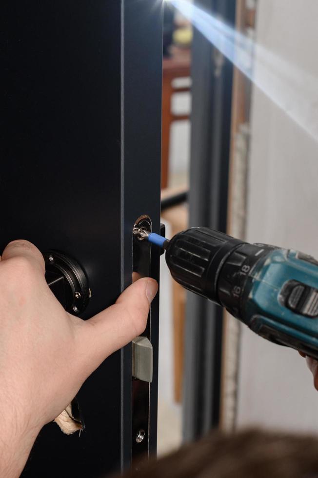 Installation of a door handle on interior doors, carpentry work with doors. photo