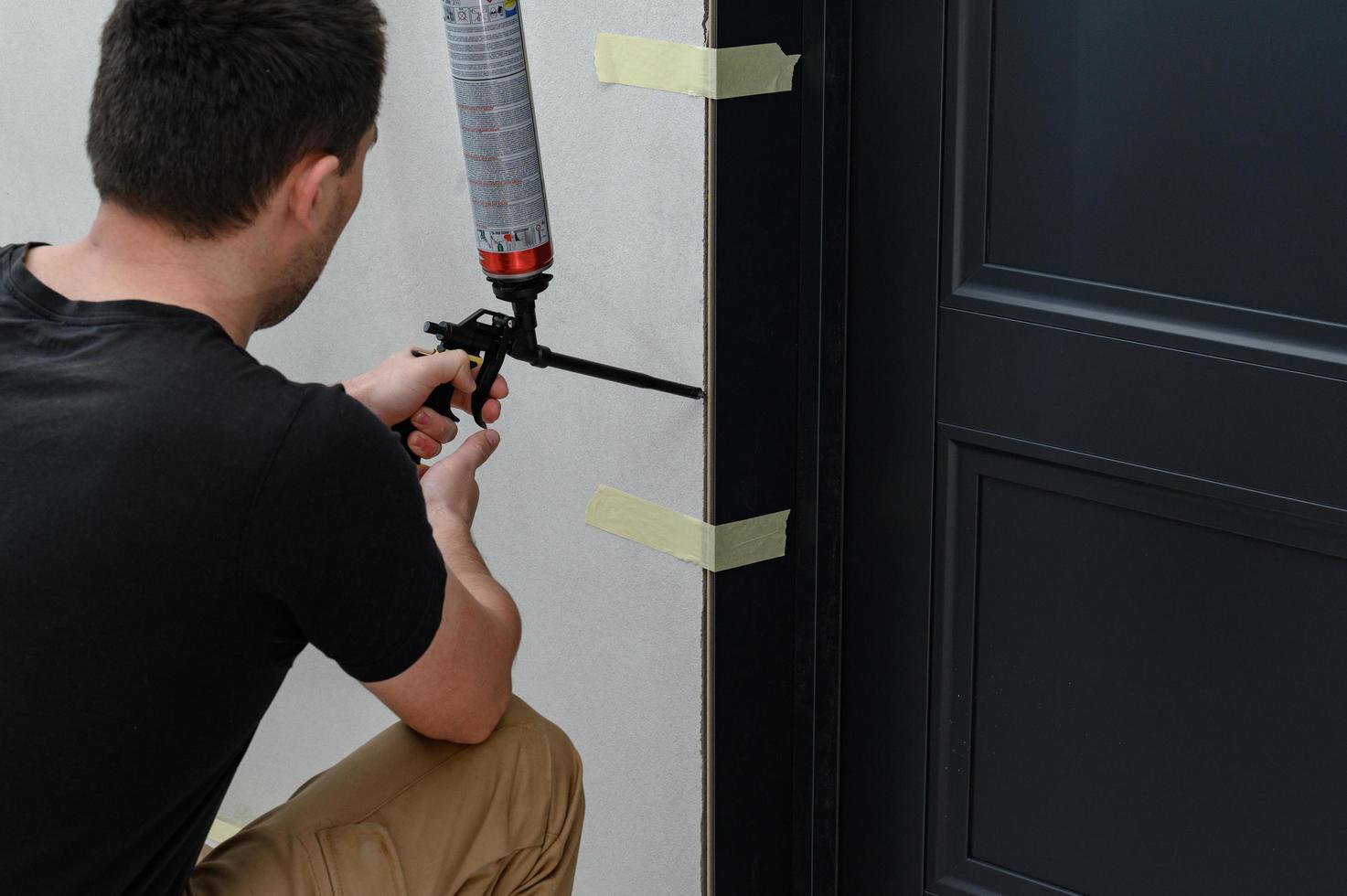 The use of mounting foam with a spray gun in construction works, installation of interior doors. photo