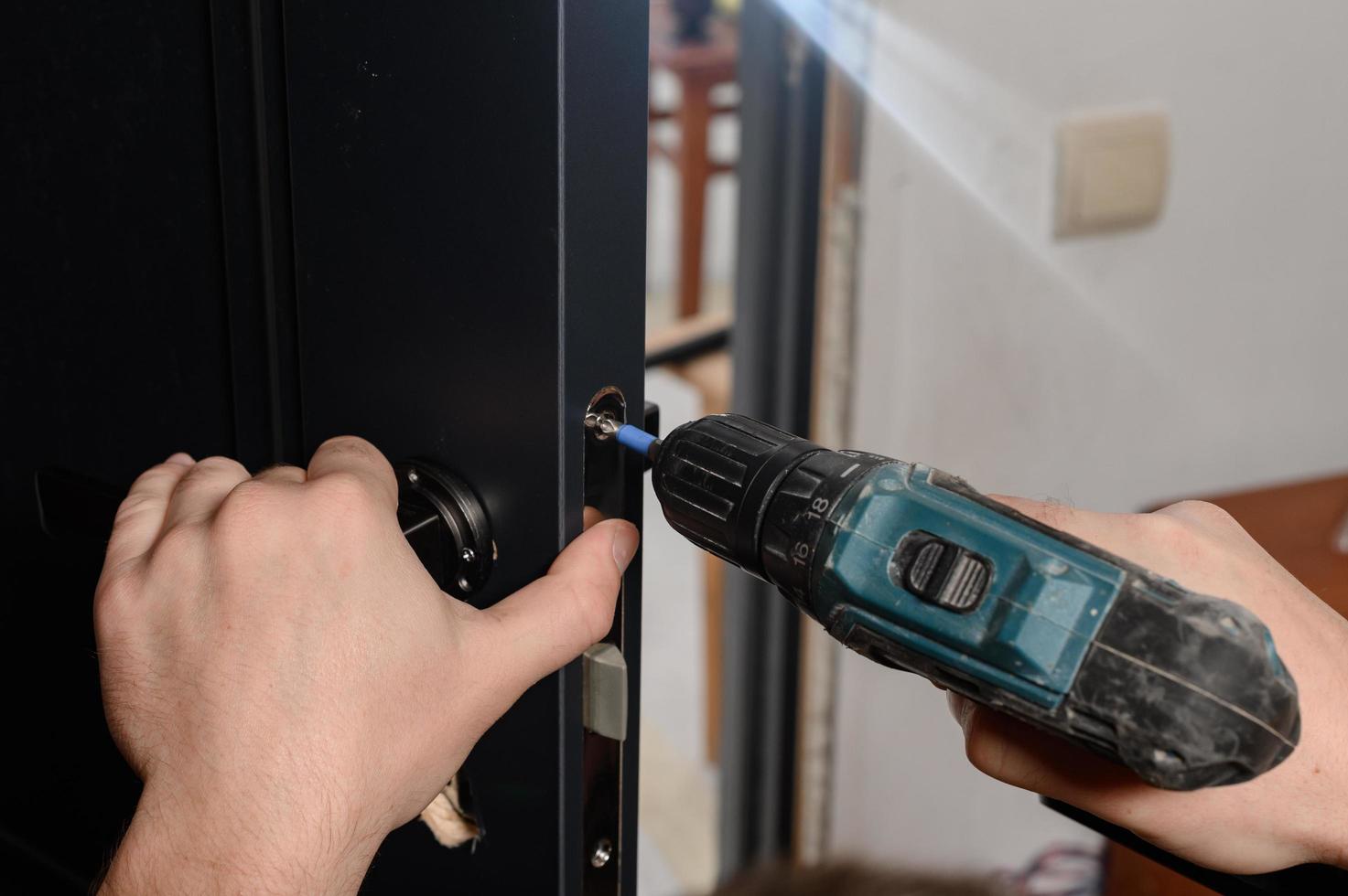 Installation of a door handle on interior doors, carpentry work with doors. photo