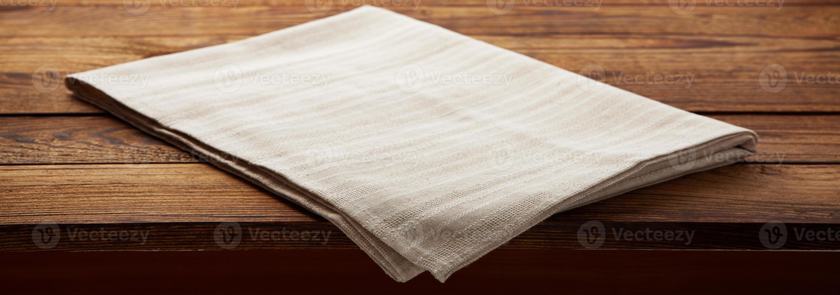 Empty canvas napkin on wooden desk top view photo