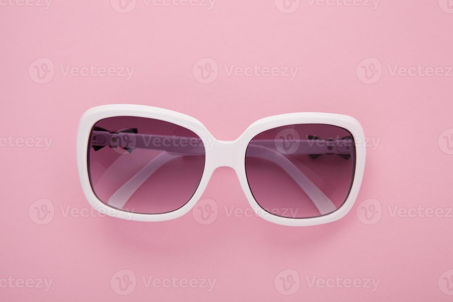 Summer background. Sunglasses isolated on colorful background. Top view and copy space. photo