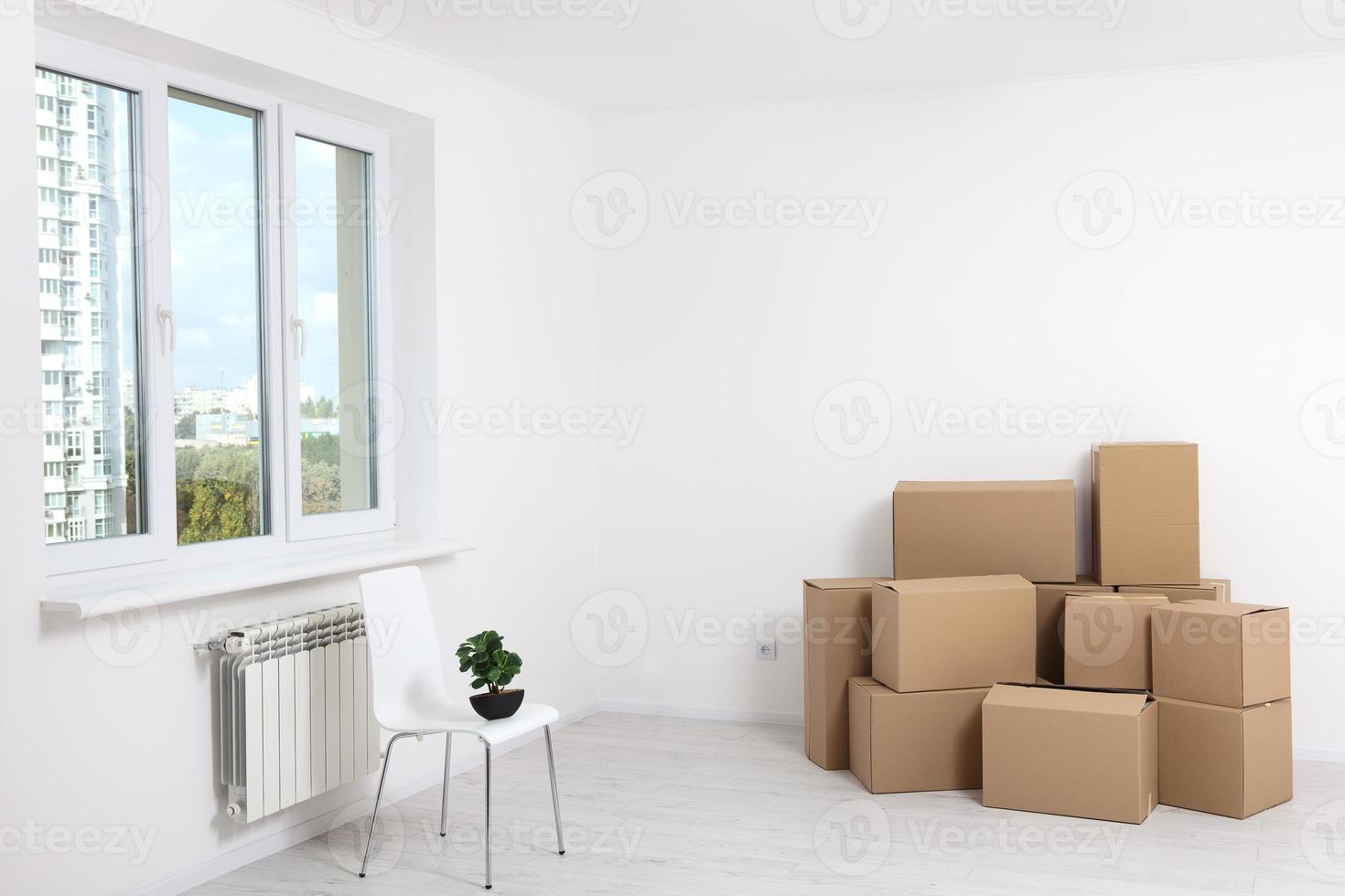 Moving into a new apartment. Move lots of cardboard boxes in an empty new apartment. photo