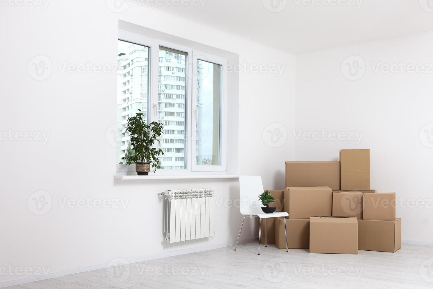 Moving into a new apartment. Move lots of cardboard boxes in an empty new apartment. photo