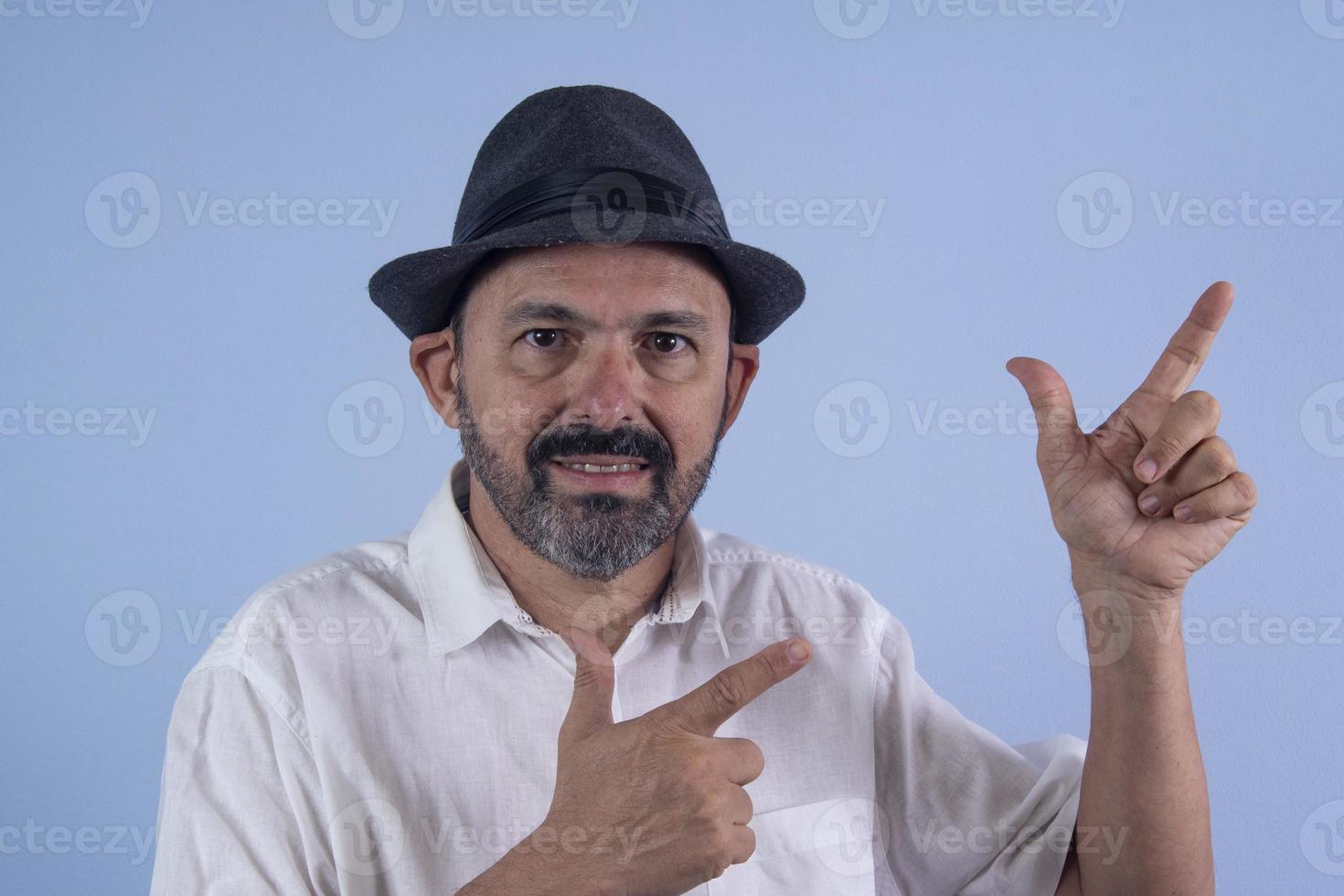 Portrait of 60 years old bearded man on blue background photo