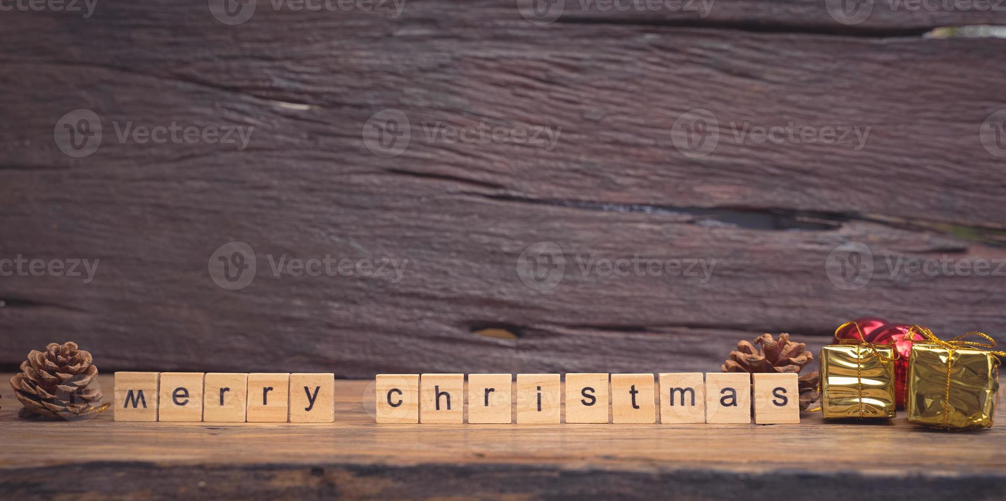 Merry Christmas. Christmas greeting card with rustic wood and ornaments. photo