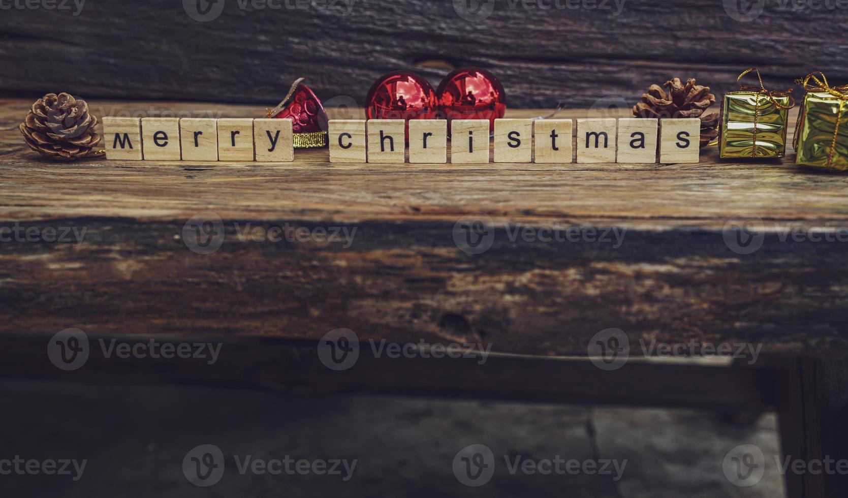 Merry Christmas. Christmas greeting card with rustic wood and ornaments. photo