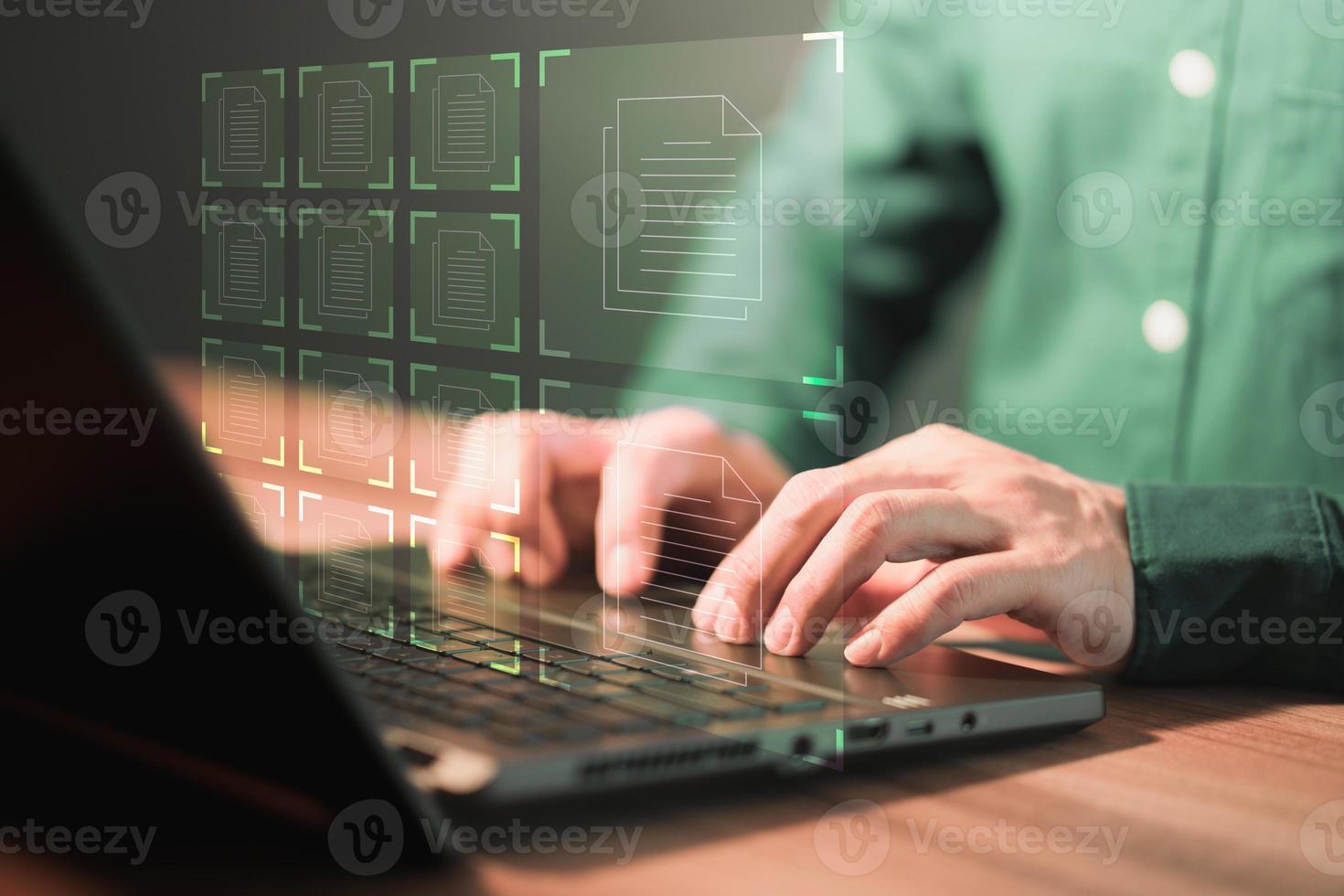 Document Management System, online documentation database and process automation to efficiently manage files. Corporate business technology. Employee man using a computer laptop in office. photo