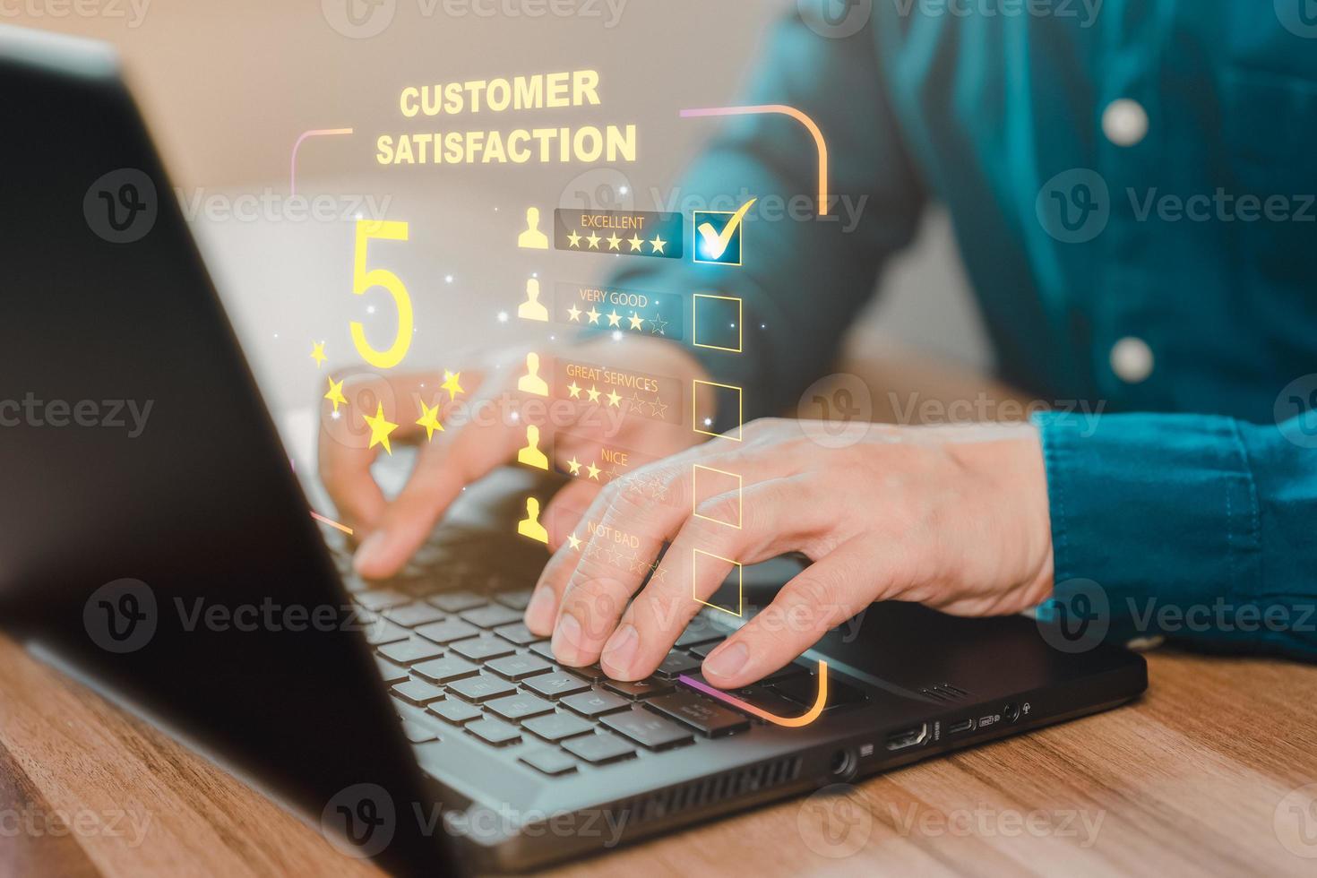 Businessman hand using computer laptop with popup five star icon for feedback review satisfaction service, testimonial. Customer service experience and business satisfaction survey. photo