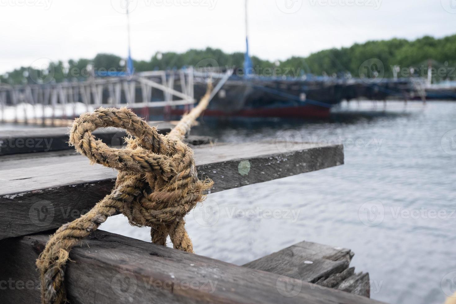 selectively focus on rope knots to tie fishing boats photo