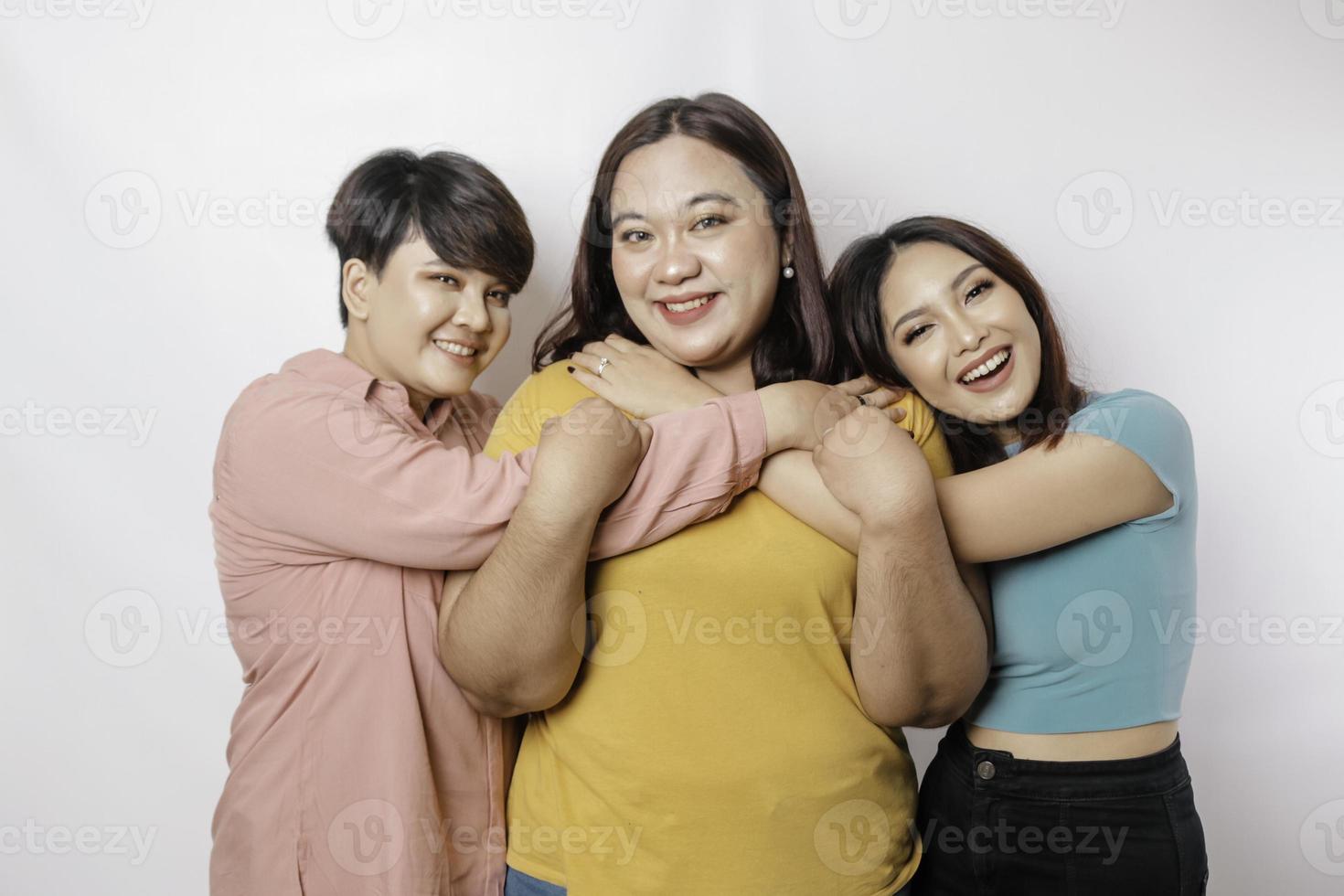 Happy three close friends hugging each other showing friendly gesture photo