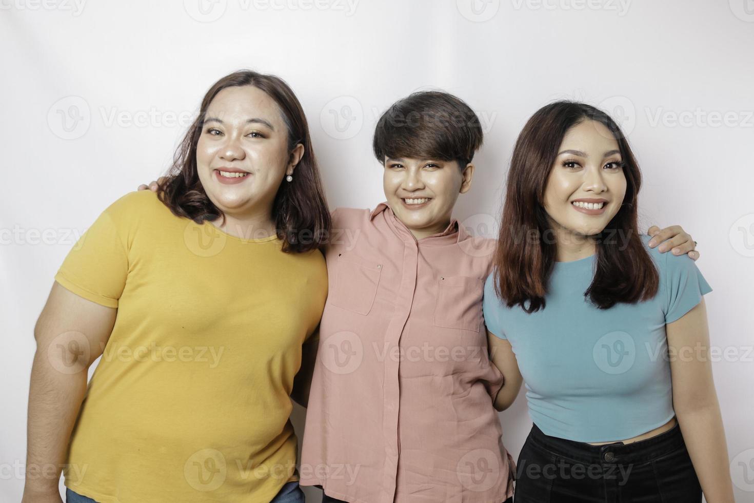 A portrait of three friends are smiling expressing happy feeling, isolated by white background photo