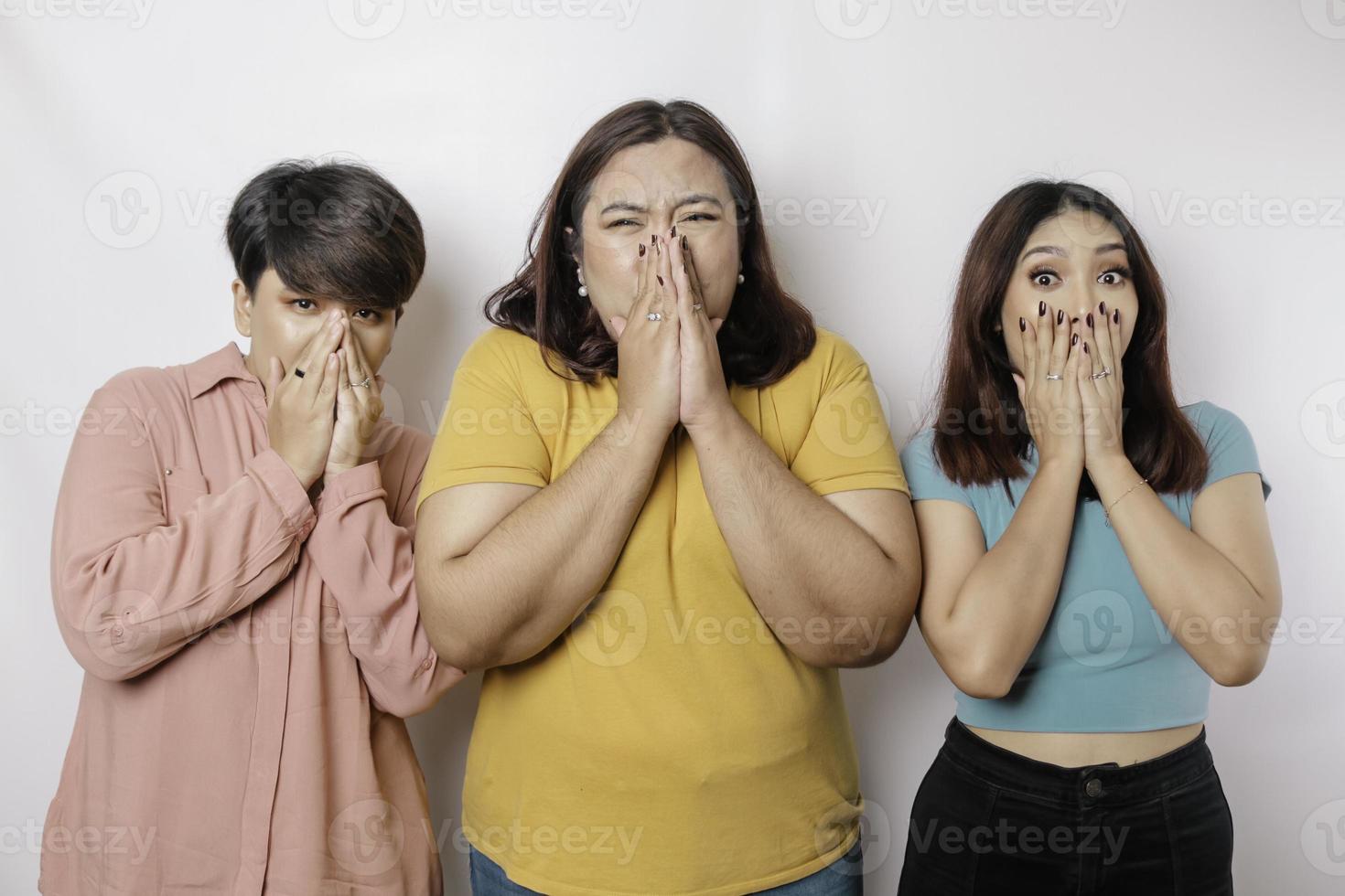 A portrait of three friends shocked, expressing disbelief feeling, isolated by a white background photo