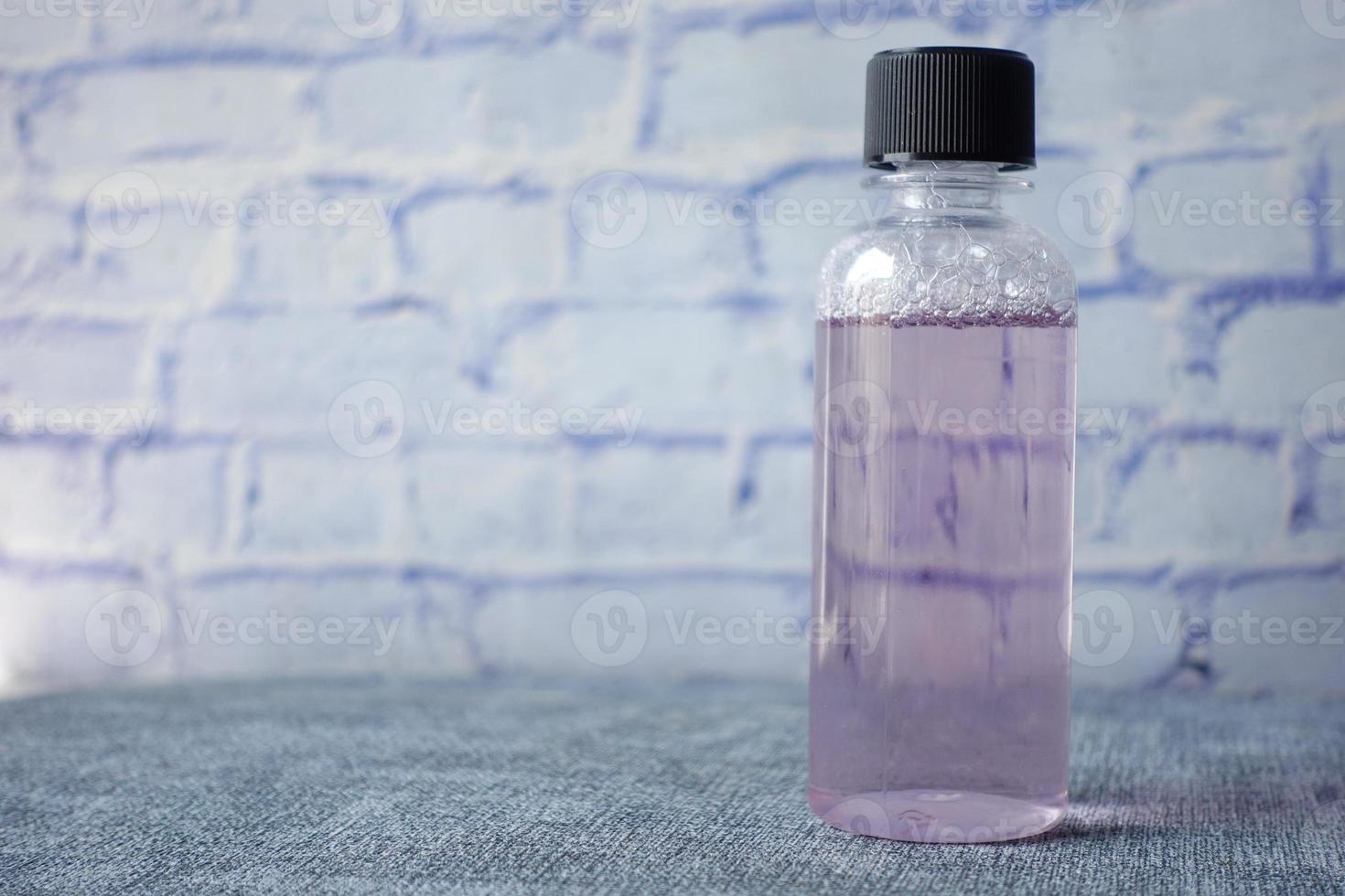 mouthwash liquid in a container on table photo