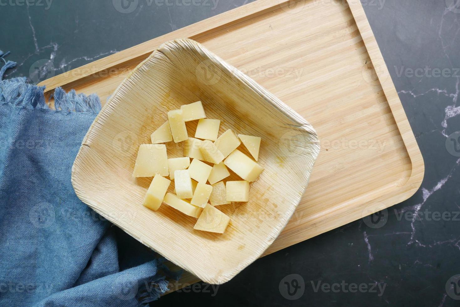 close up of cube shape fresh cheese on in a bowl photo