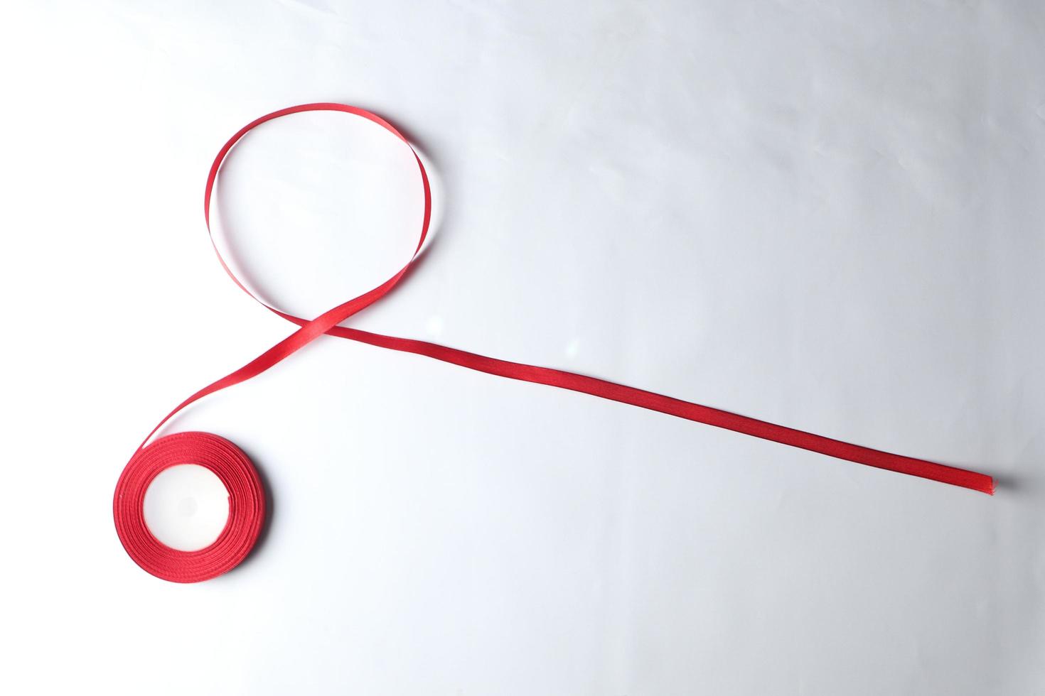 Red Support Ribbon isolated on white background. World aids day and national HIV AIDS and aging awareness month with red ribbon. copyspace area photo