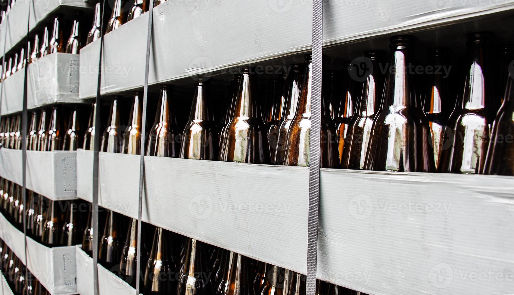 Close up beer bottle in pallet for brewing in industrial plants photo