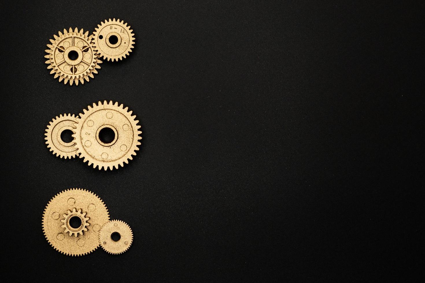 template of six golden gears on black background photo