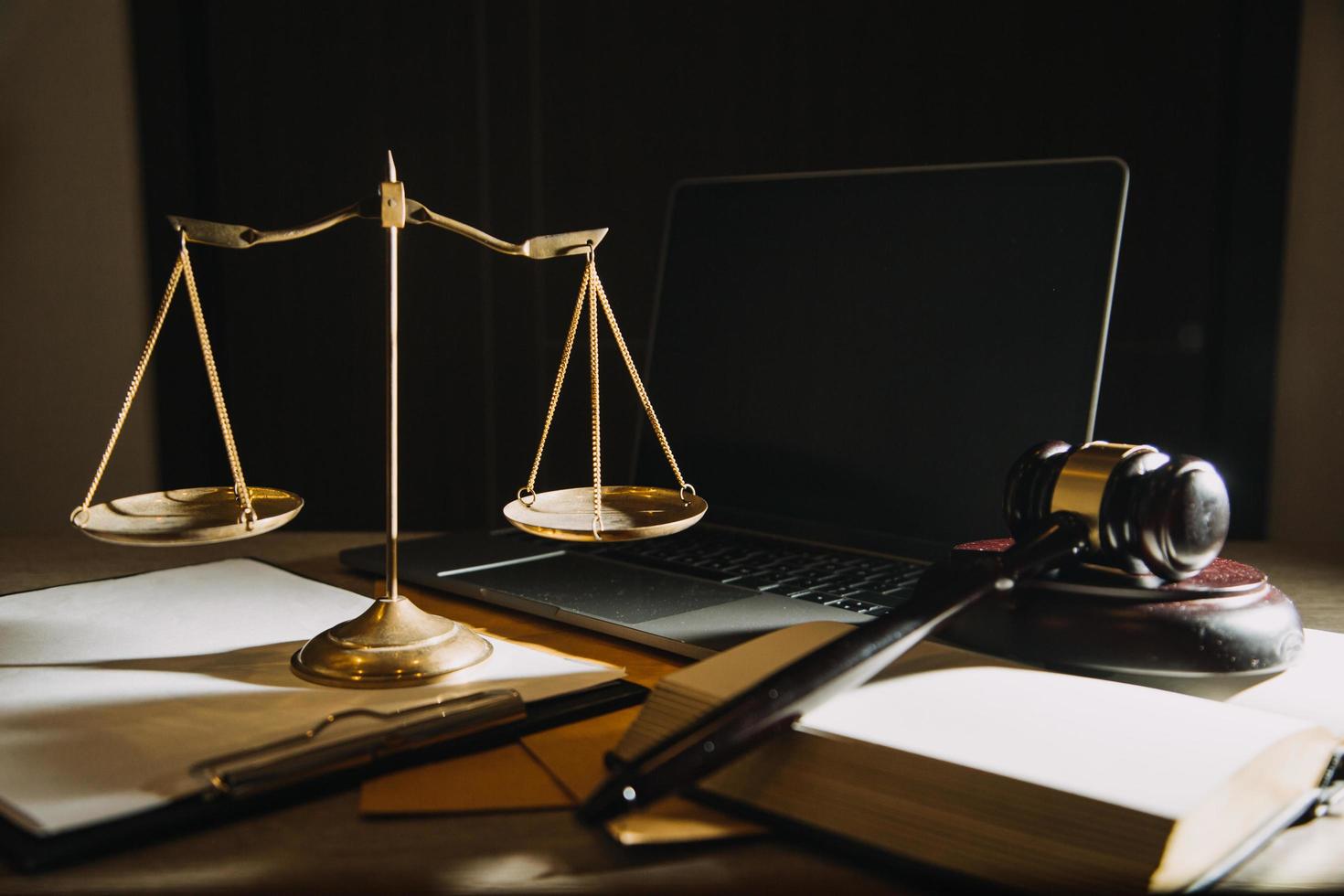 Business and lawyers discussing contract papers with brass scale on desk in office. Law, legal services, advice, justice and law concept photo