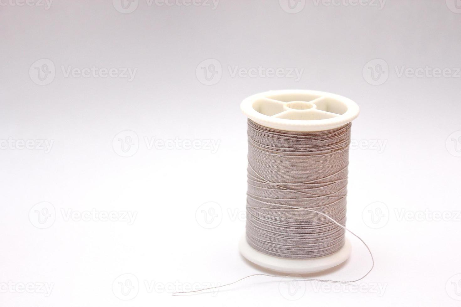 Gray spools placed on a white background. photo