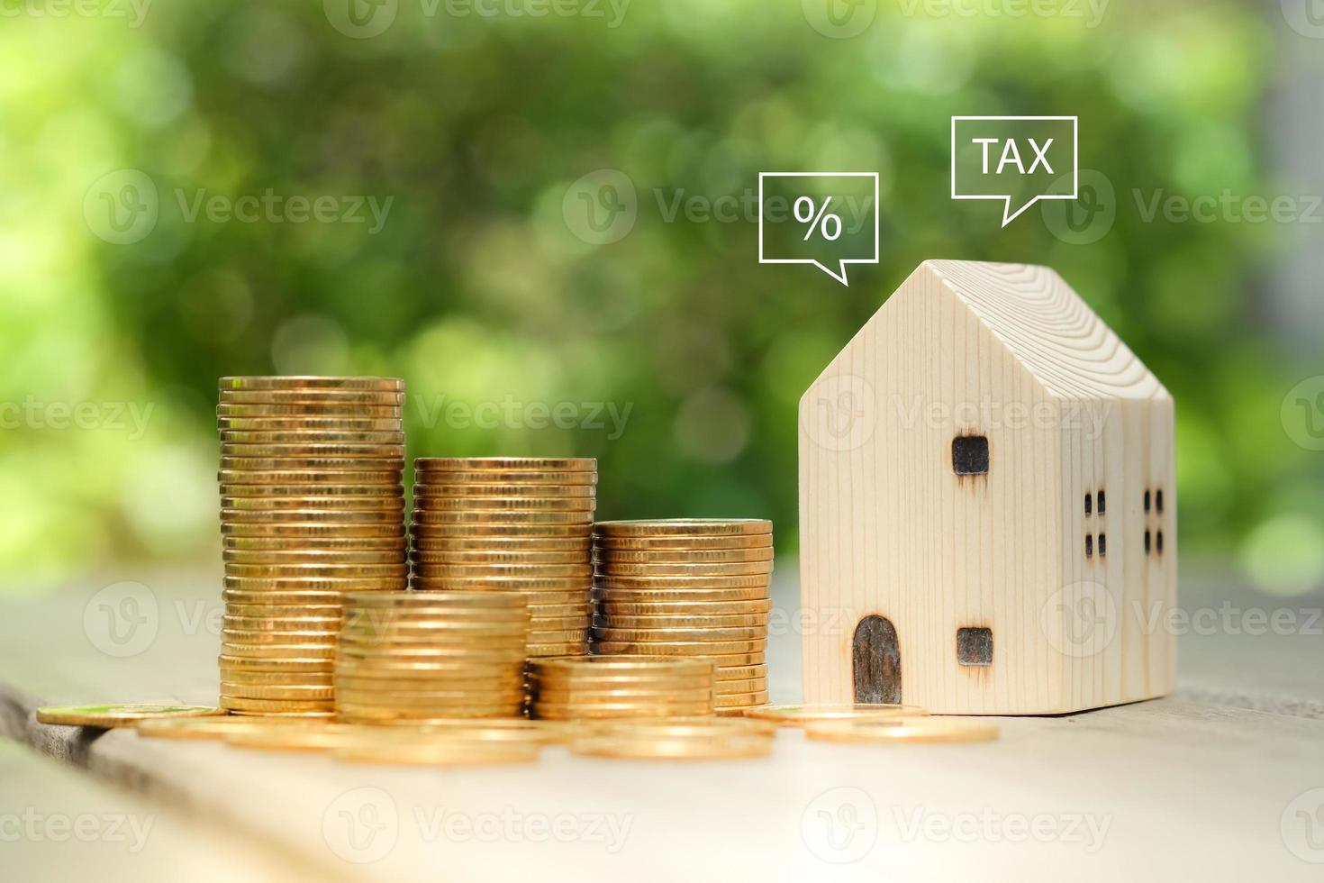Percentage sign and TAX on speech bubble from house with money coin stack. Real estate concept. Property investment, loan, mortgage, tax. Home price or increase of interest rate. photo