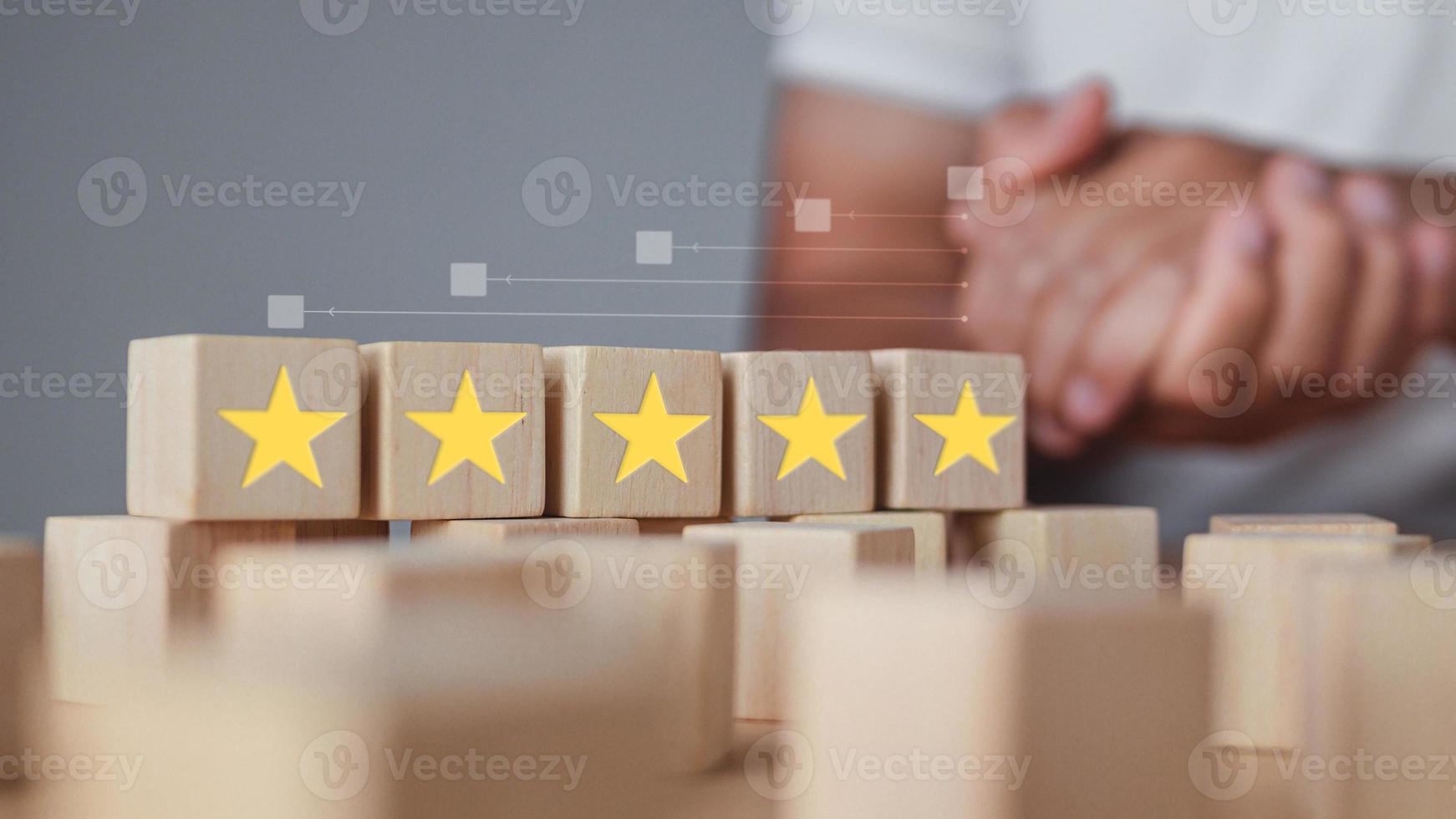 Welcome gesture of Receptionist. All wood blocks are five stars. It shows an excellent job and best service for customer. Evaluation and satisfaction concept. photo