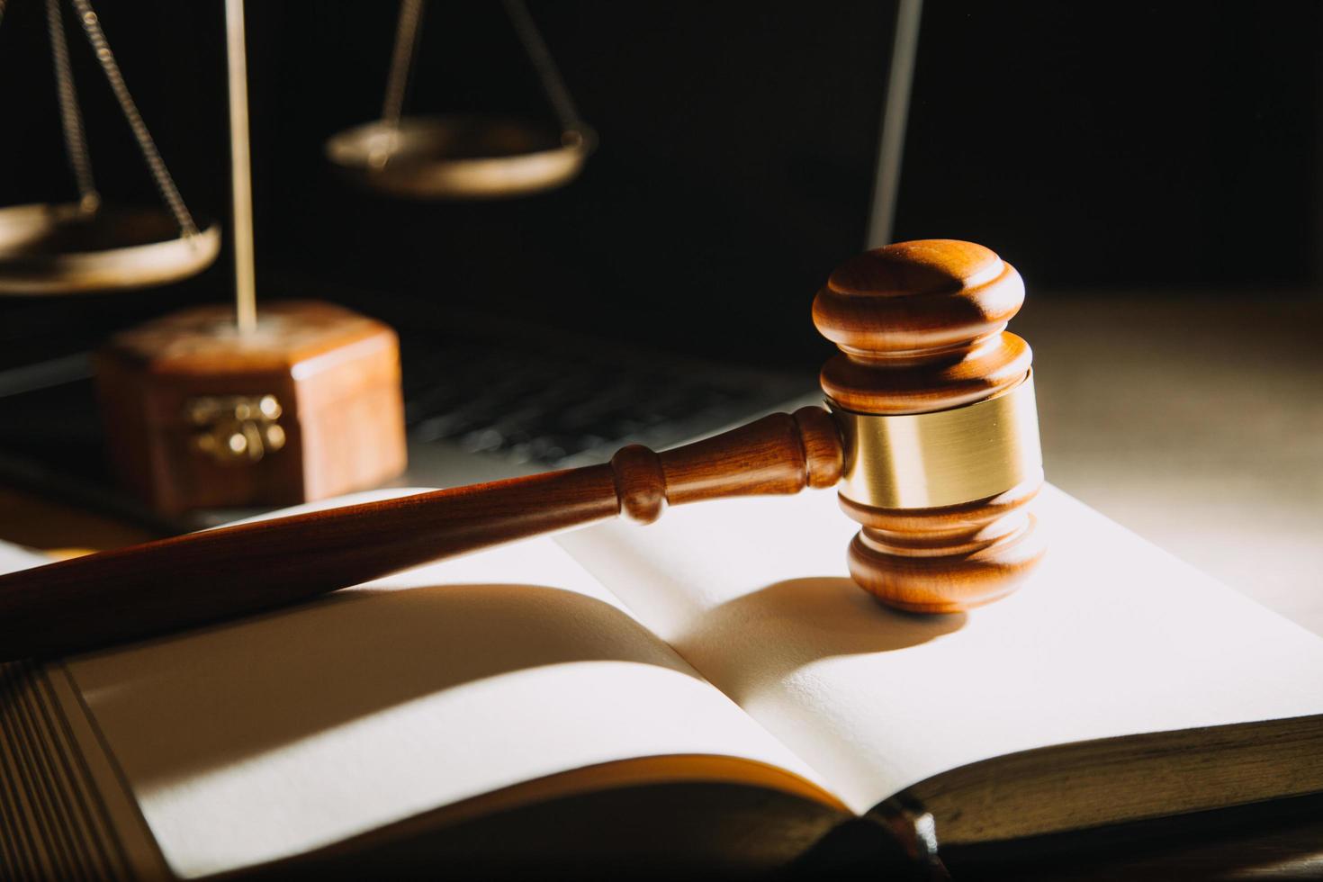 Business and lawyers discussing contract papers with brass scale on desk in office. Law, legal services, advice, justice and law concept picture with film grain effect photo