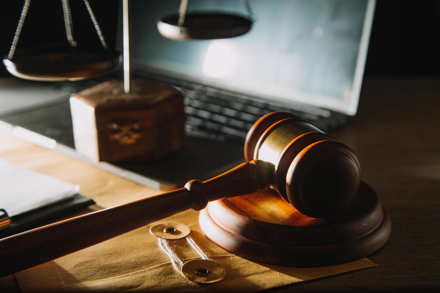 Business and lawyers discussing contract papers with brass scale on desk in office. Law, legal services, advice, justice and law concept picture with film grain effect photo