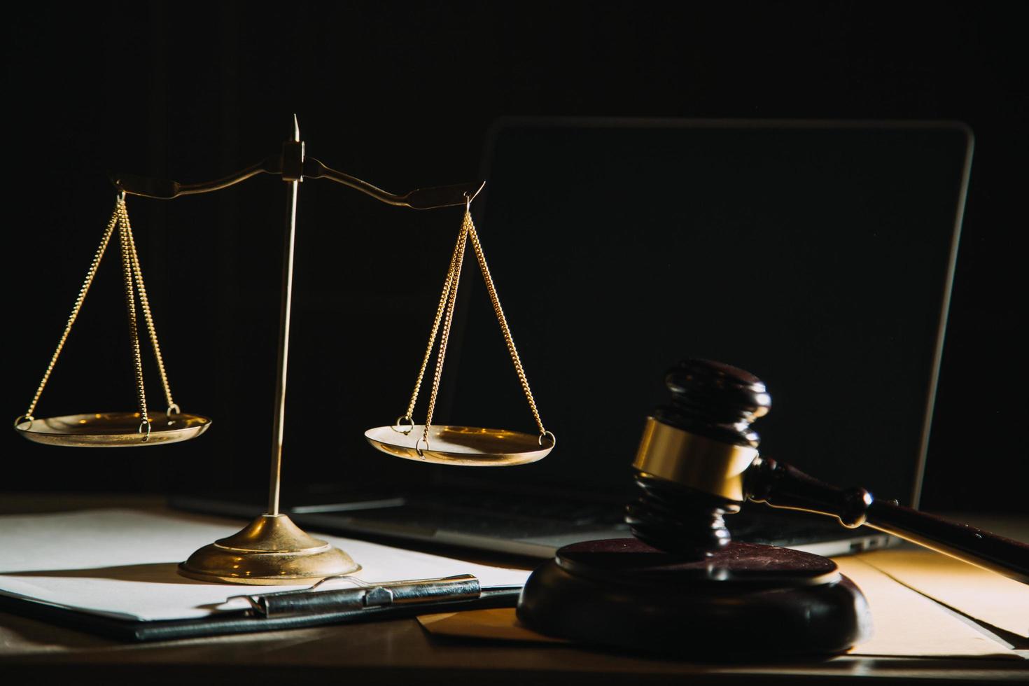 Business and lawyers discussing contract papers with brass scale on desk in office. Law, legal services, advice, justice and law concept picture with film grain effect photo