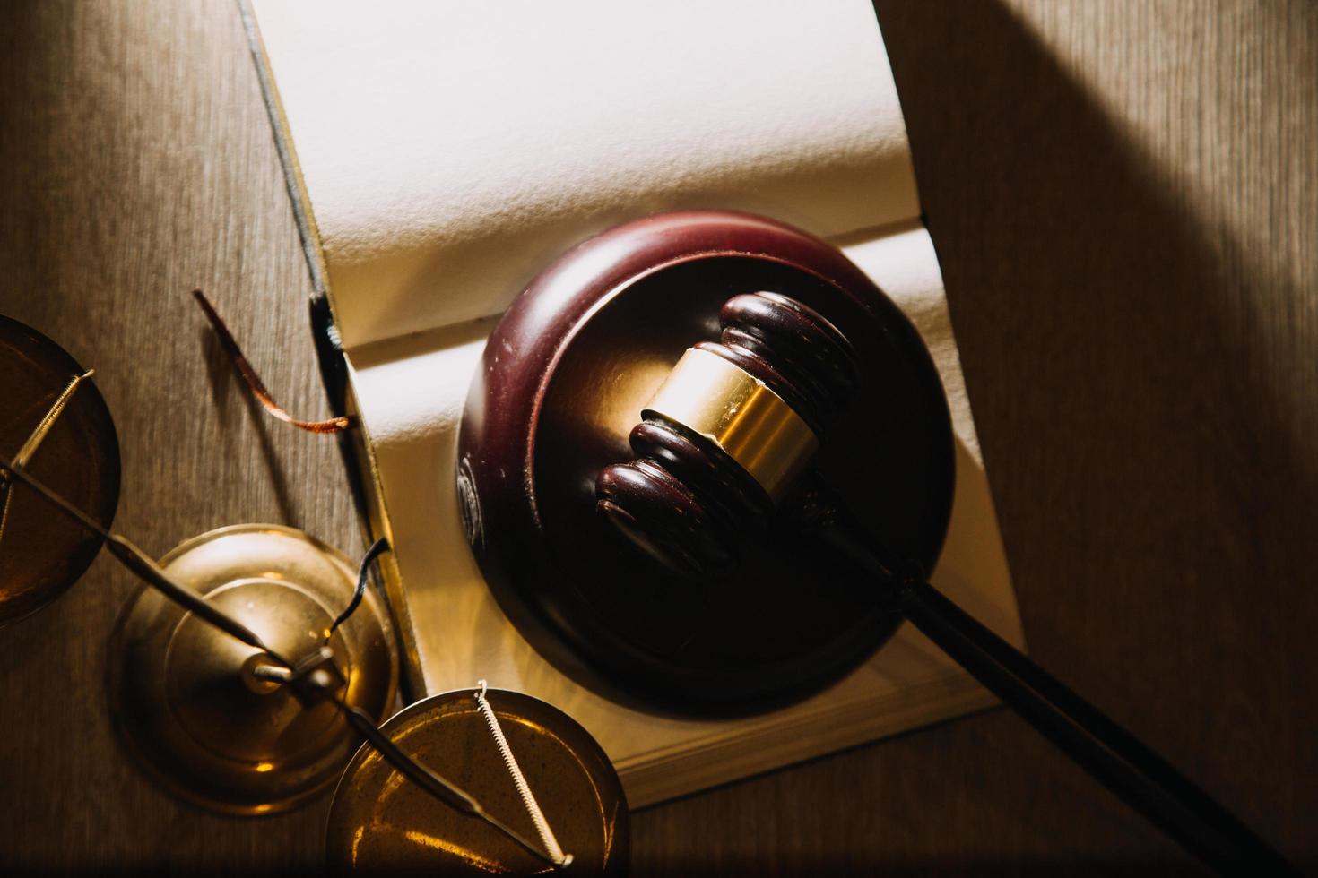 Business and lawyers discussing contract papers with brass scale on desk in office. Law, legal services, advice, justice and law concept picture with film grain effect photo