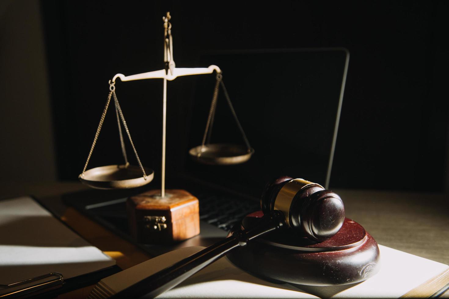 Business and lawyers discussing contract papers with brass scale on desk in office. Law, legal services, advice, justice and law concept picture with film grain effect photo