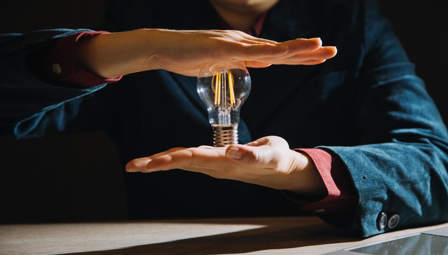 hand holding light bulb. idea concept with innovation and inspiration photo