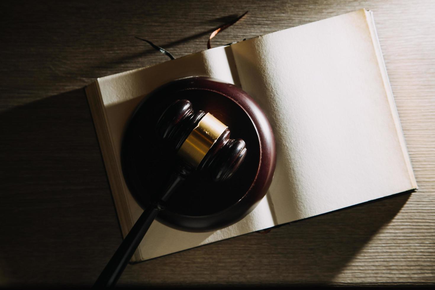 Business and lawyers discussing contract papers with brass scale on desk in office. Law, legal services, advice, justice and law concept picture with film grain effect photo