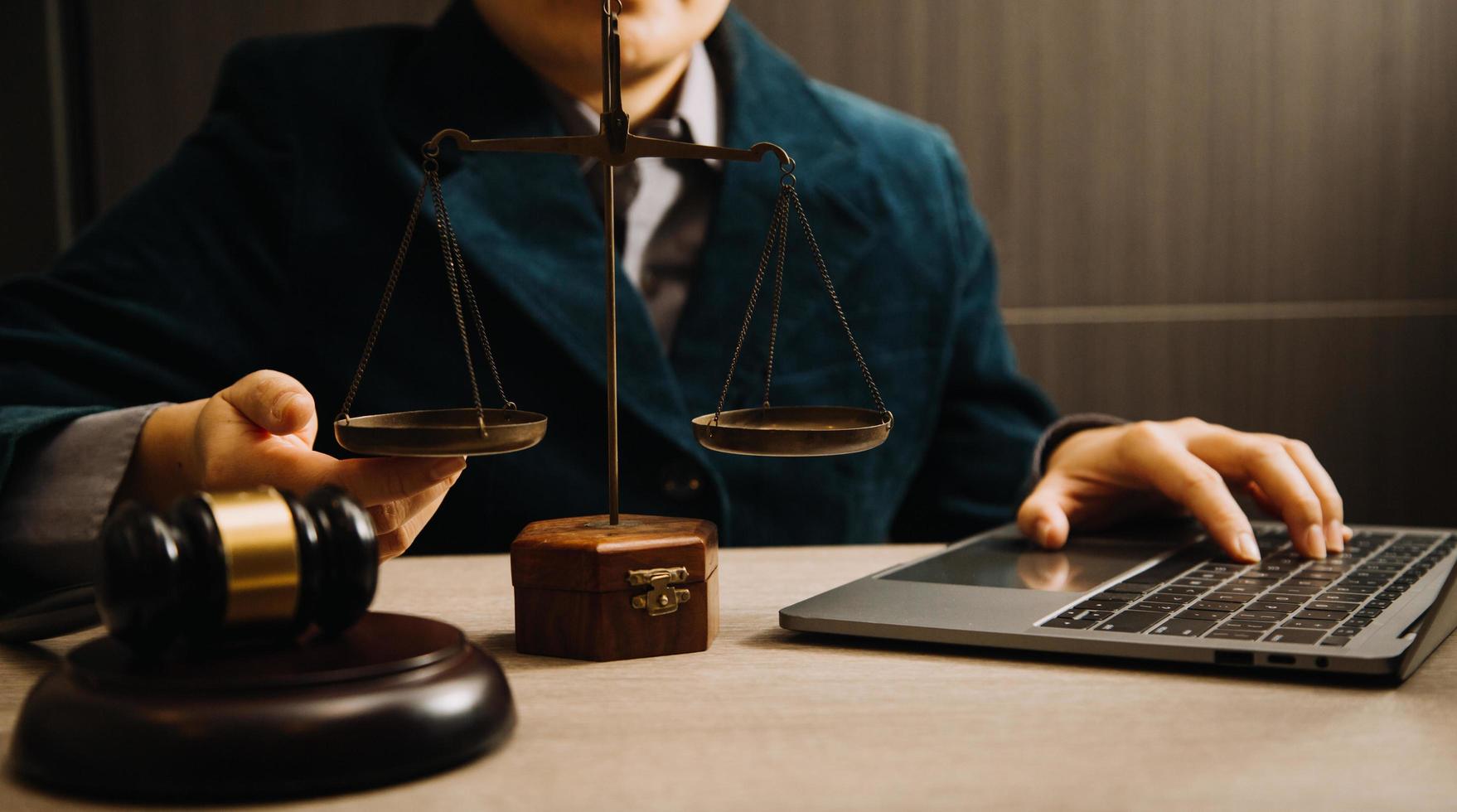 Business and lawyers discussing contract papers with brass scale on desk in office. Law, legal services, advice, justice and law concept picture with film grain effect photo