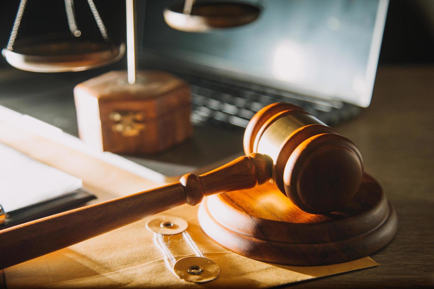 Business and lawyers discussing contract papers with brass scale on desk in office. Law, legal services, advice, justice and law concept picture with film grain effect photo