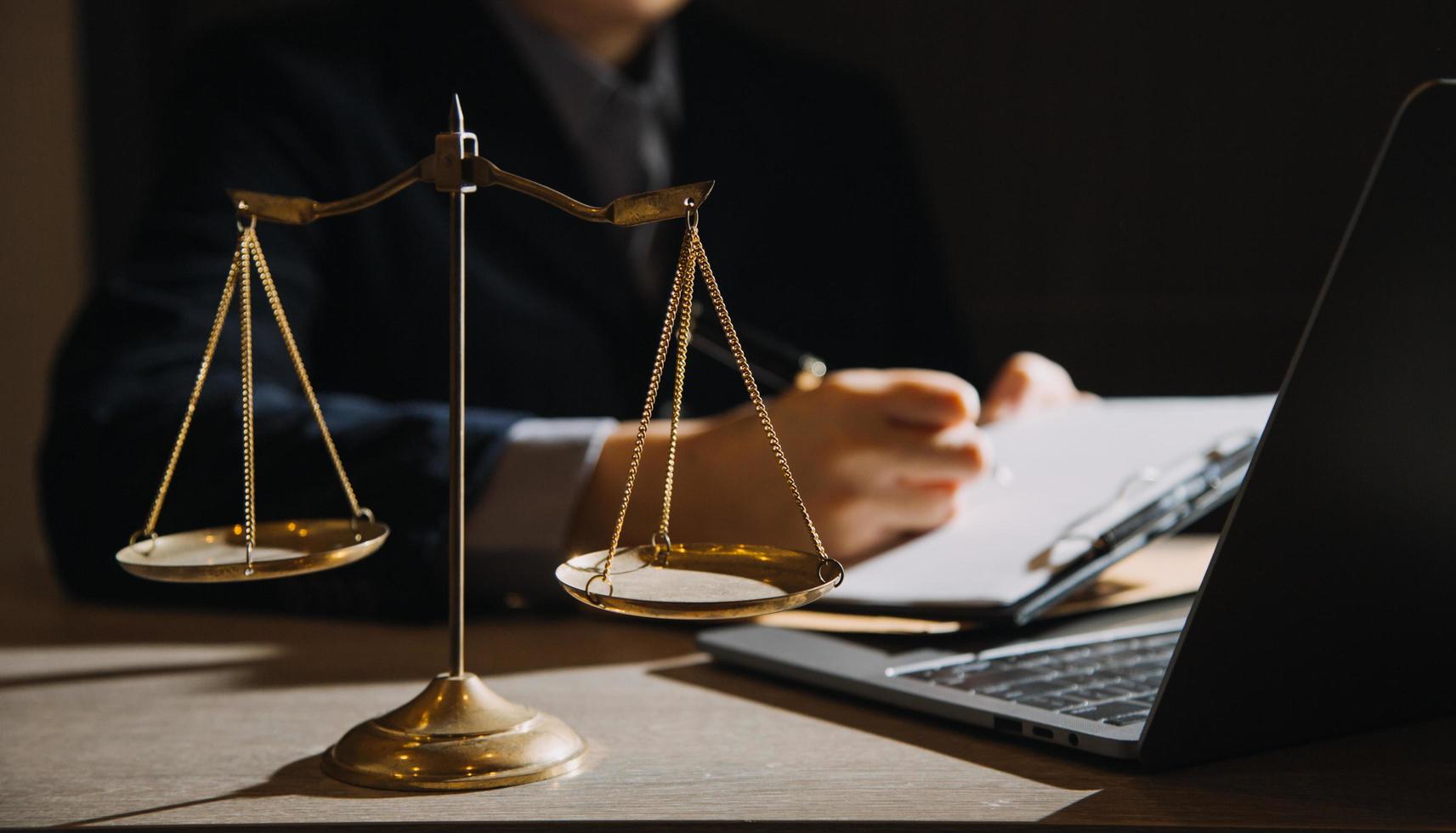 Business and lawyers discussing contract papers with brass scale on desk in office. Law, legal services, advice, justice and law concept picture with film grain effect photo
