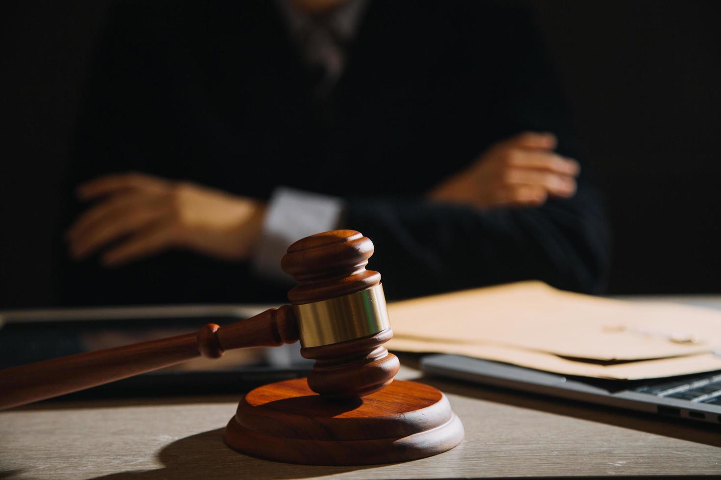 Business and lawyers discussing contract papers with brass scale on desk in office. Law, legal services, advice, justice and law concept picture with film grain effect photo
