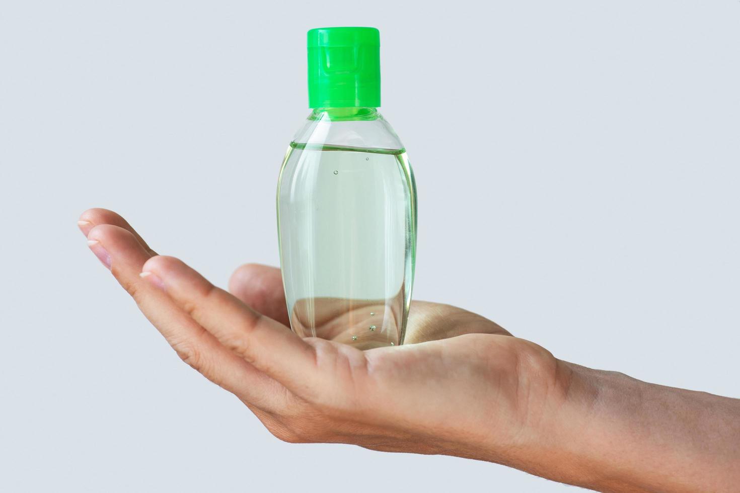 Hand with a small bottle of hand sanitizer 14394438 Stock Photo at Vecteezy